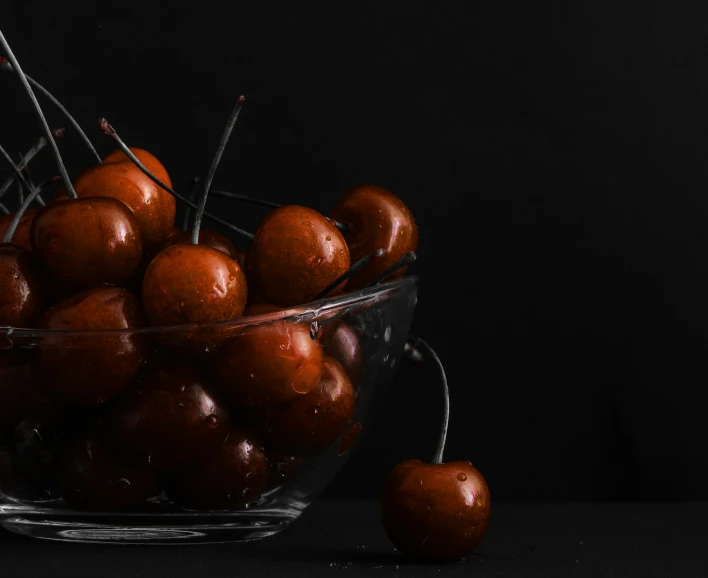 a glass bowl filled with small pieces of fruit