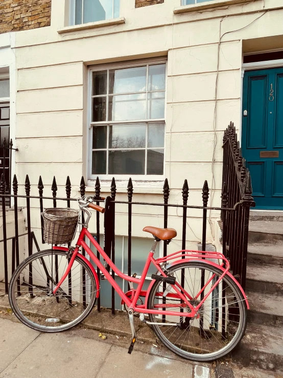 a red bicycle parked outside of a house