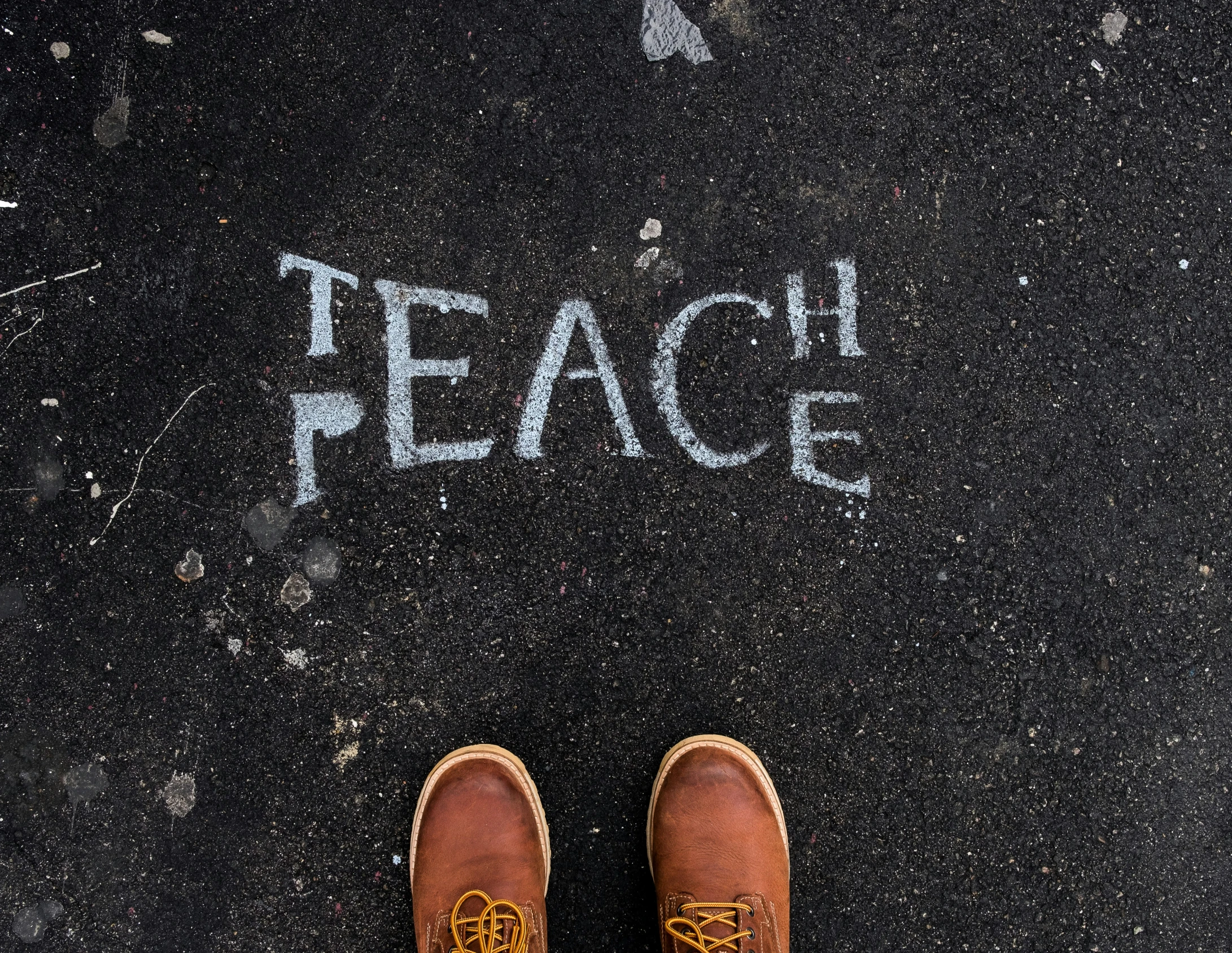 a pair of shoes next to a word peace