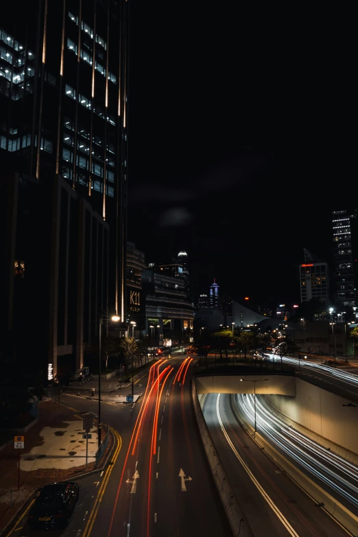 city skyline and roads with cars coming down the street