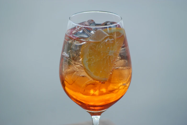 a glass with some orange and other types of food inside