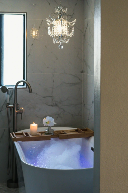 a tub with candles in it in a bathroom