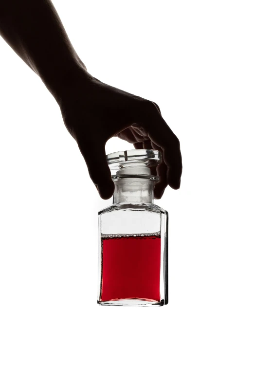 a person holds a jar of liquid with both hands