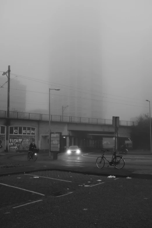 a person riding a bicycle on a foggy road