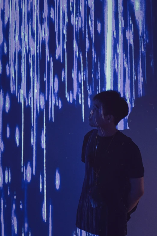 a man standing in front of a projected curtain