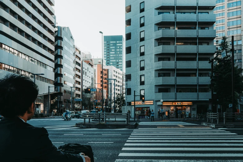 someone riding a bike in a city, with buildings around them