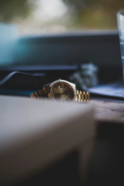 a view from the table, showing a watch in front of the glass