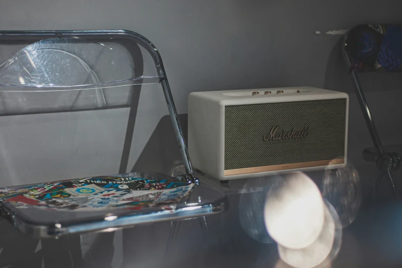 the room has a chair and an old radio on it