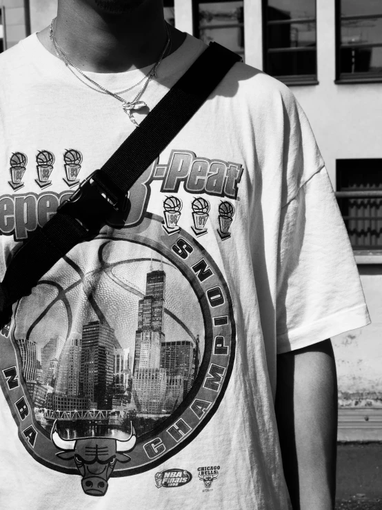 a boy is holding his black and white camera strap