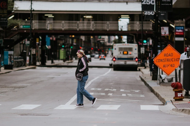 a man crossing the street at an intersection with traffic