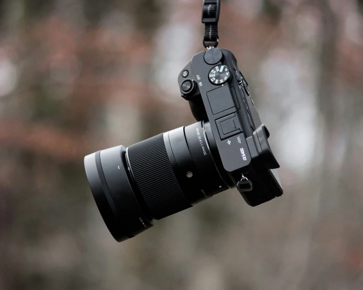 an upside down camera hanging from a rope