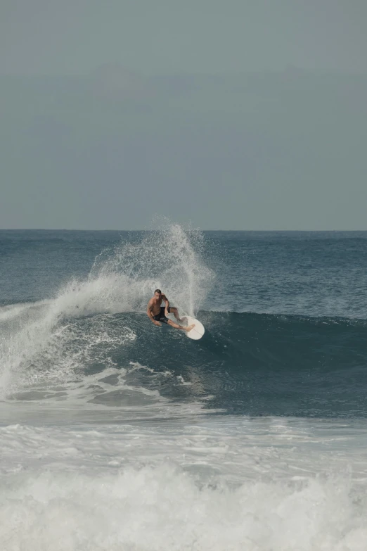 a surfer on his surfboard catching a large wave