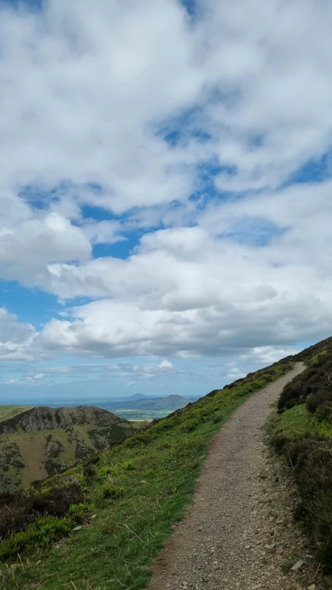 a dirt path and road passing between the mountains