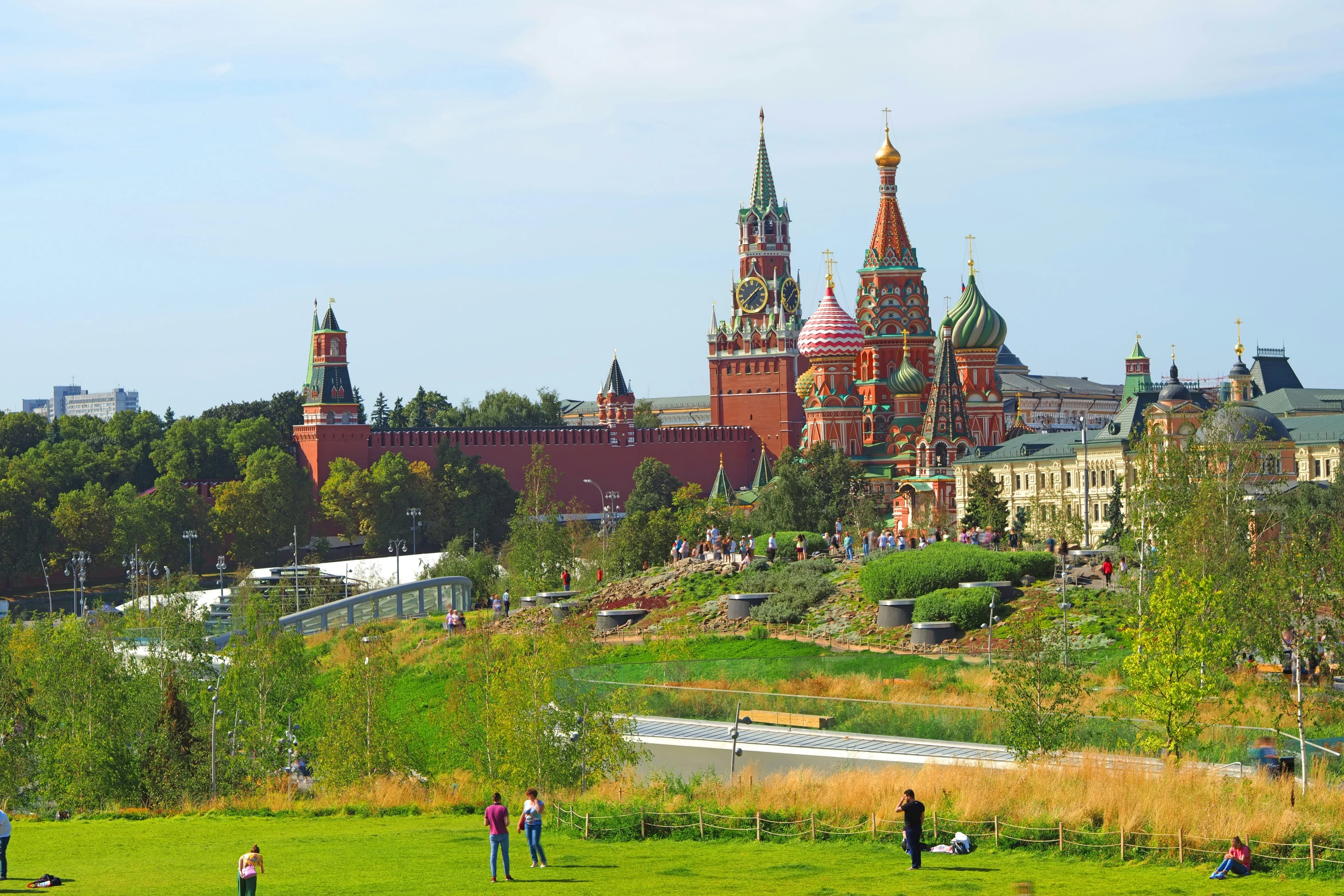 a grassy hill with many people standing on it