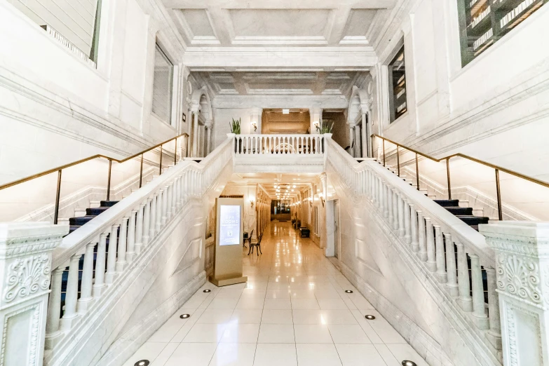 a very long marble covered hall leading to other rooms