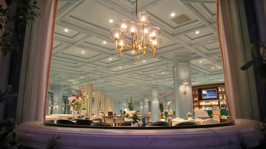 a room with a large chandelier and a dining table