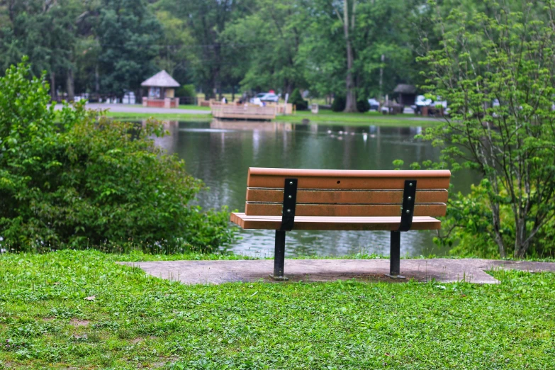 a park bench overlooking a lake and park