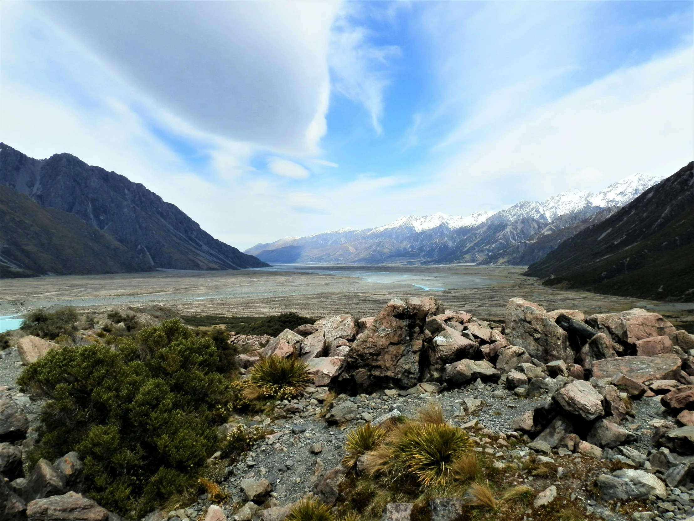 a rocky mountain area with a view of mountains