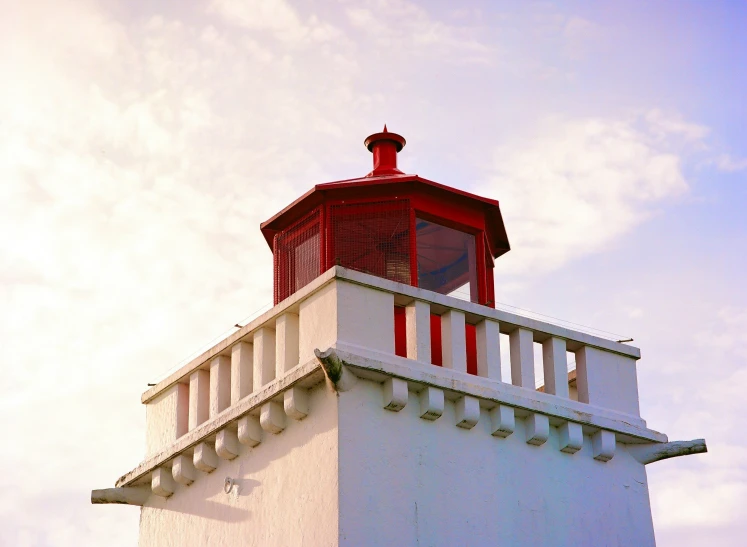 red and white light house against the sky