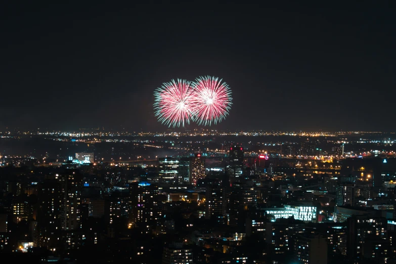 a fireworks display is lit up over the city