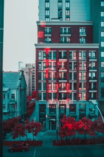 a picture of an apartment building through a glass window
