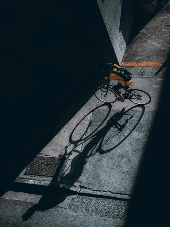 a bicycle casts a shadow in a room
