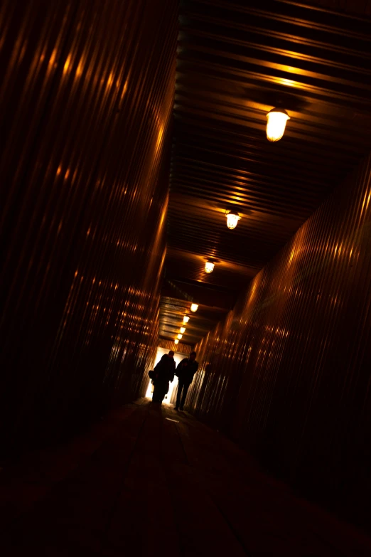 a dark tunnel where two people are standing