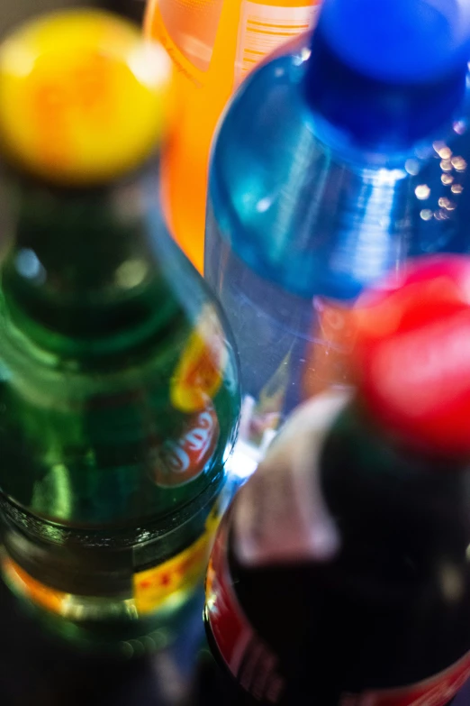 several bottles with different colored lids and caps on them