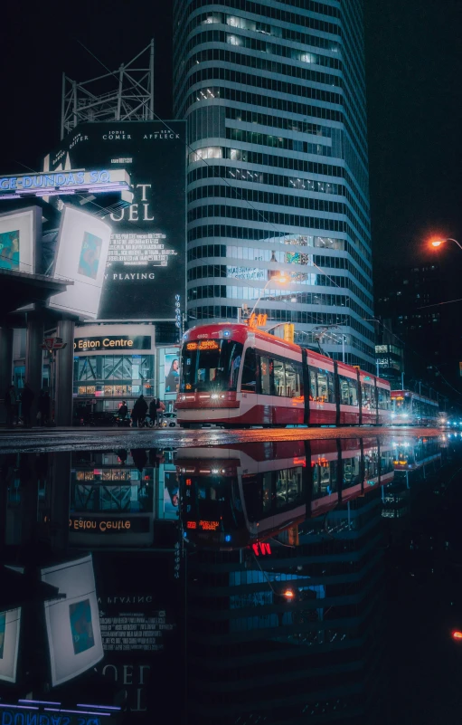 the city skyline with a red bus stopped in front of it