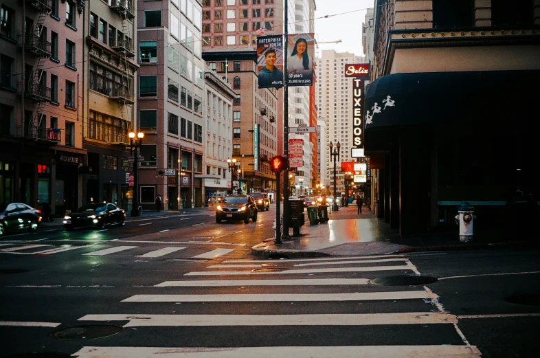 a wet city street with lots of buildings on it