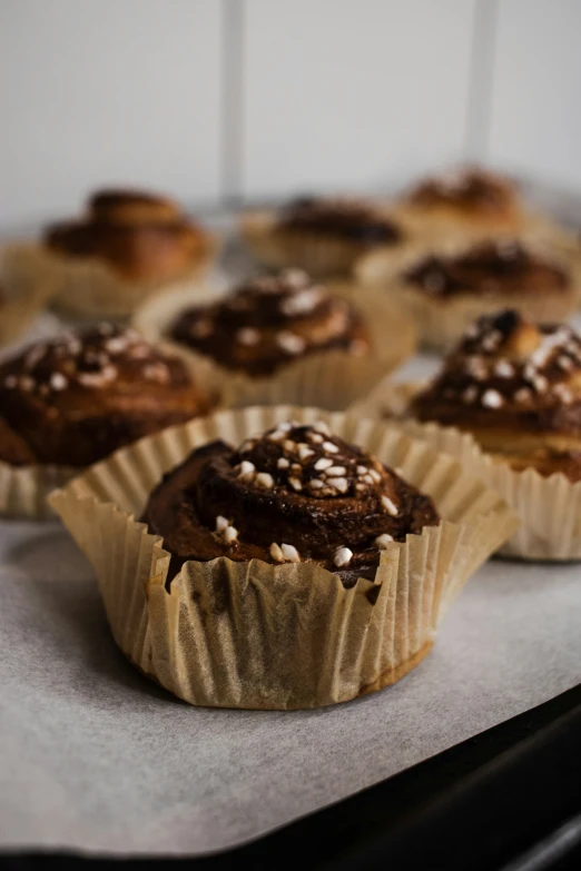 a plate that has some chocolate cupcakes on it