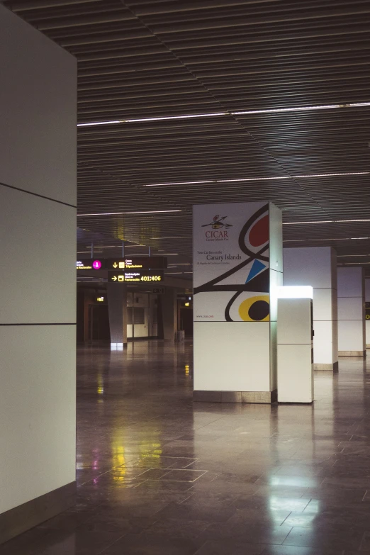 an empty building with a sign and other signage on the wall