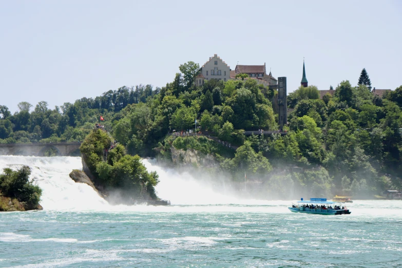 a large blue boat in the water next to an island