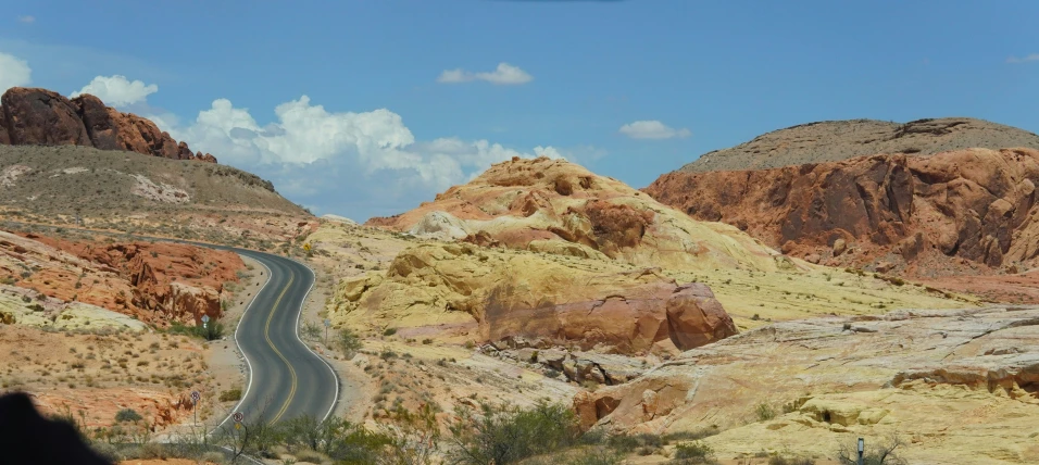 a group of large rocks sitting on the side of a road