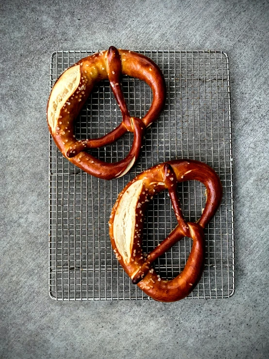 two pretzels that are sitting on a metal surface