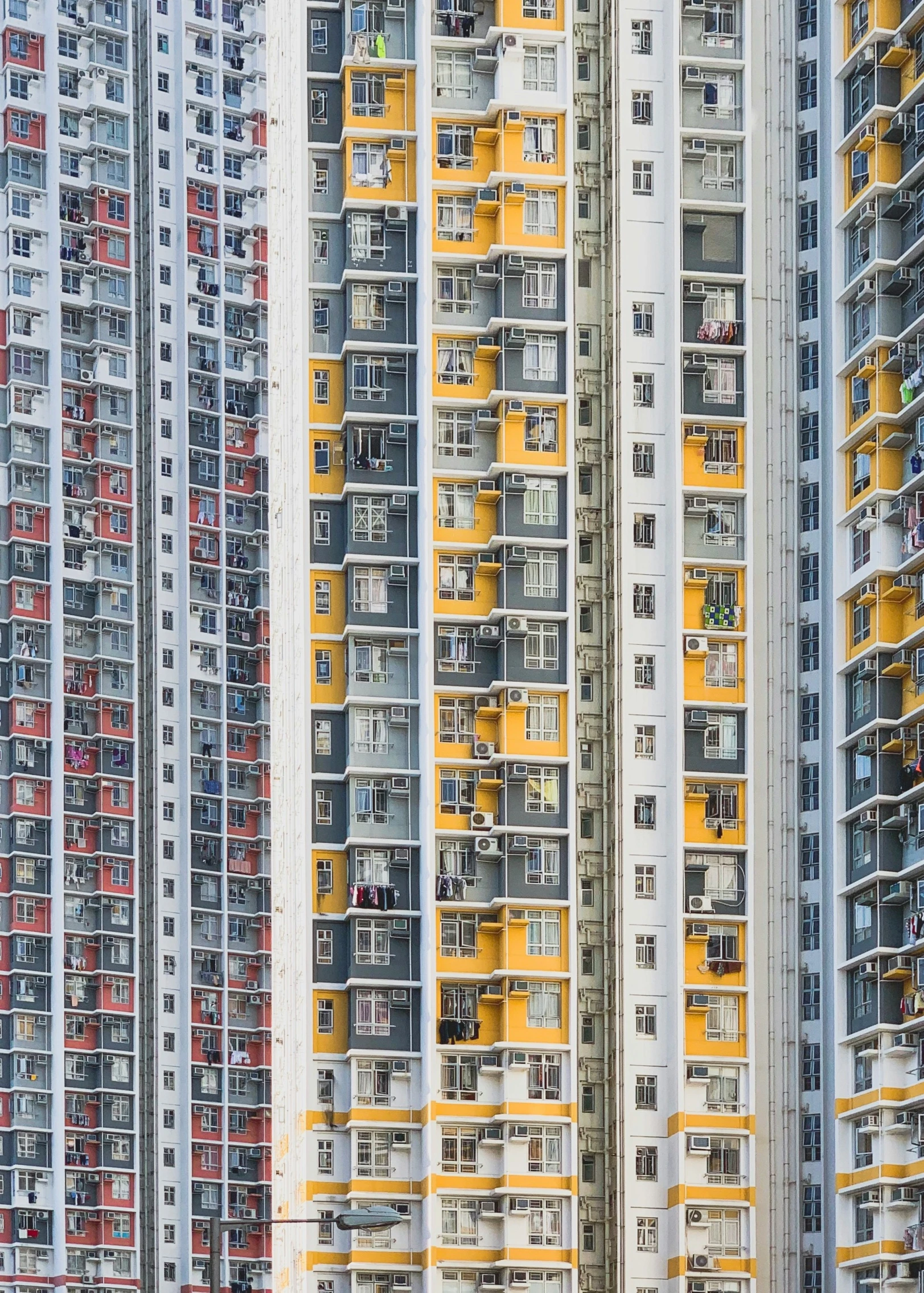 a large multicolored building with yellow and black balconies