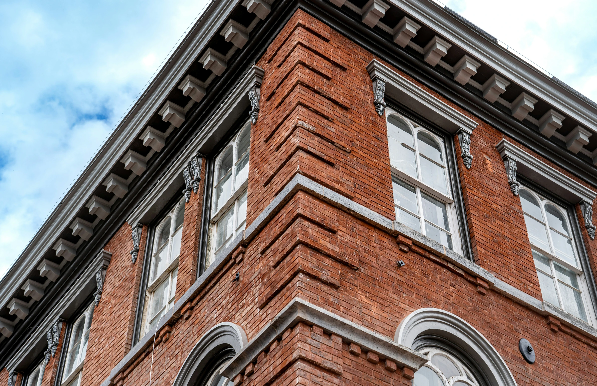 looking up at an old building with no window