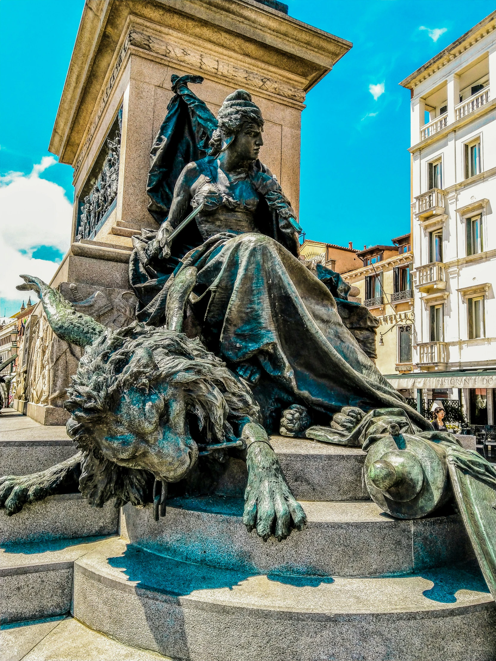 a sculpture sits in front of a building in a city