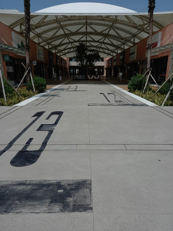 a bus stop is shown with two buses parked