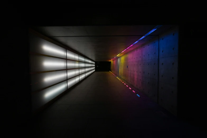 a tunnel with bright colored lights and several different colors