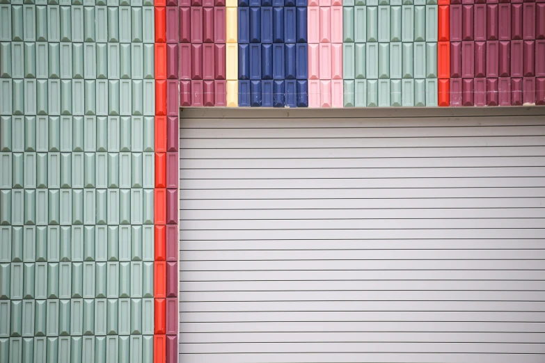 three colorful doors in front of an empty garage