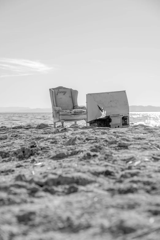 two beach chairs sitting next to each other in the sand