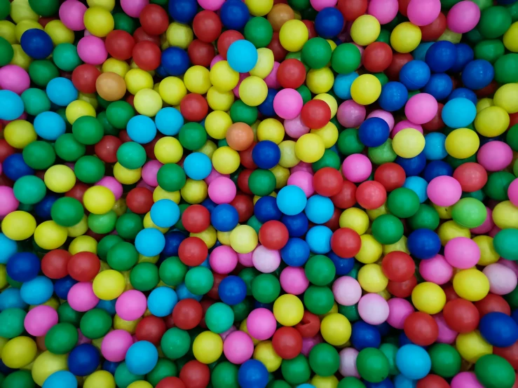 colorful balls and some water on a table