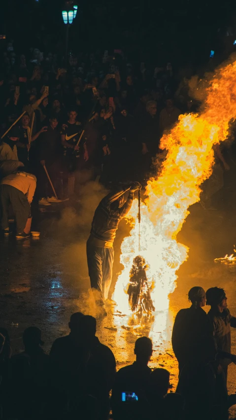 people standing near a fire show and a woman riding on the back