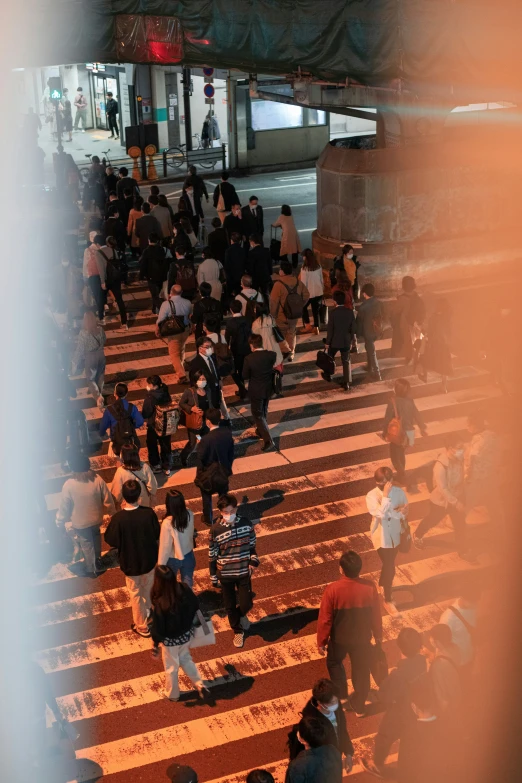 many people crossing an underpass at night