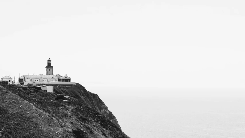 a lighthouse perched on top of a cliff