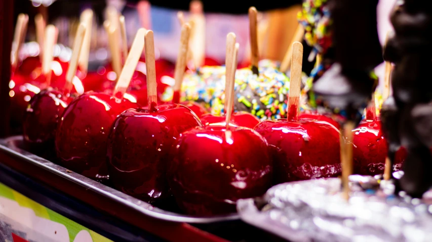 chocolate covered apples are in a tray on a table