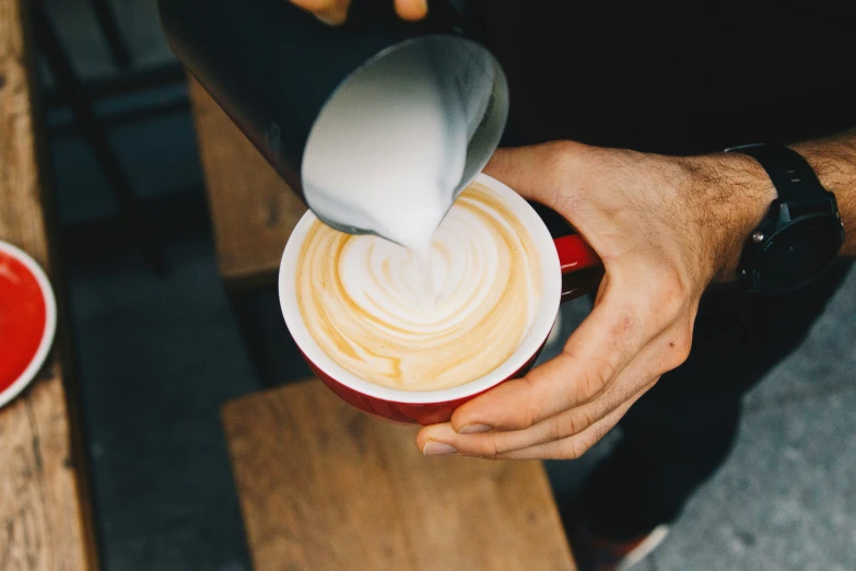 a cup with liquid that has been created into a heart