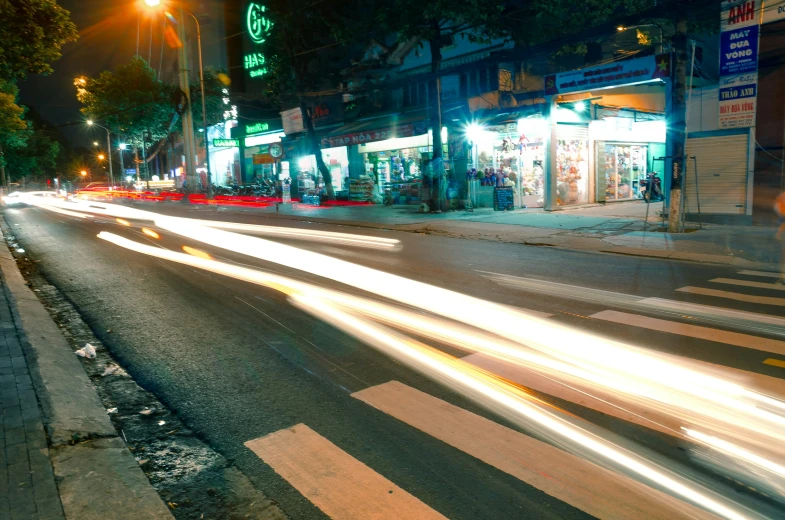 the cars are driving down the street at night