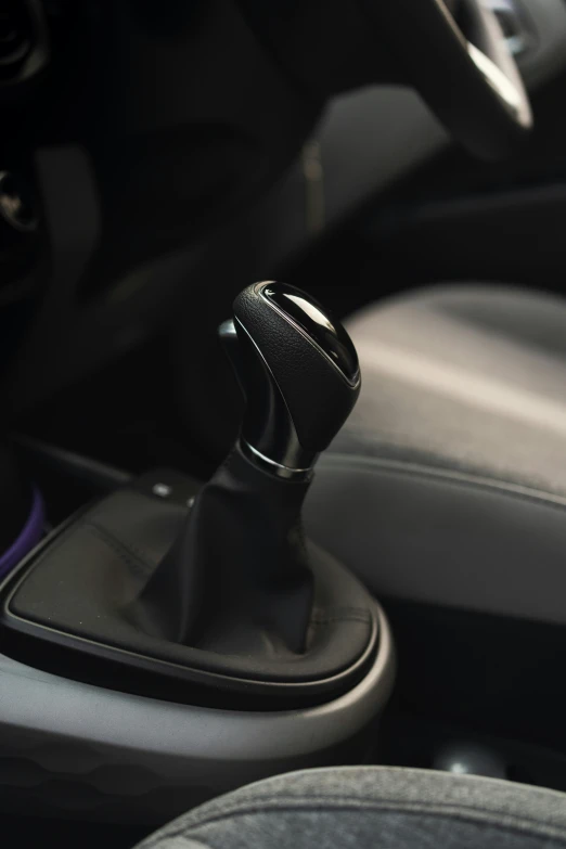 a closeup of a small manual steering wheel  on a car